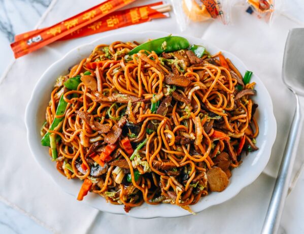 Plate of Roast Pork Lo Mein with chopsticks and fortune cookies